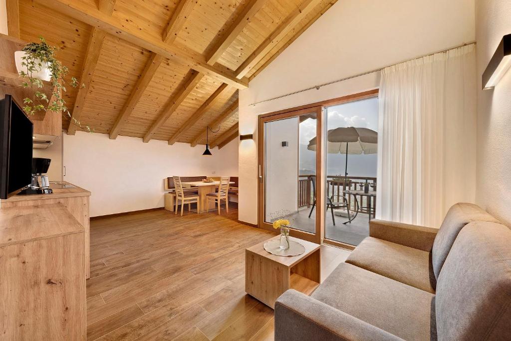 a living room with a couch and a table at Unterötzbauerhof - Fewo Rosenblick in Tirolo