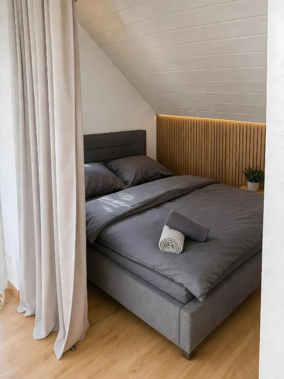 a bedroom with a large bed with a curtain at Appartement Seefreunde in Langenargen