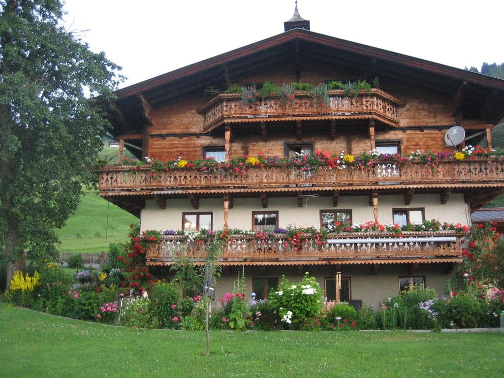 a house with flowers on the side of it at Oberbründlingchalet in Taxenbach