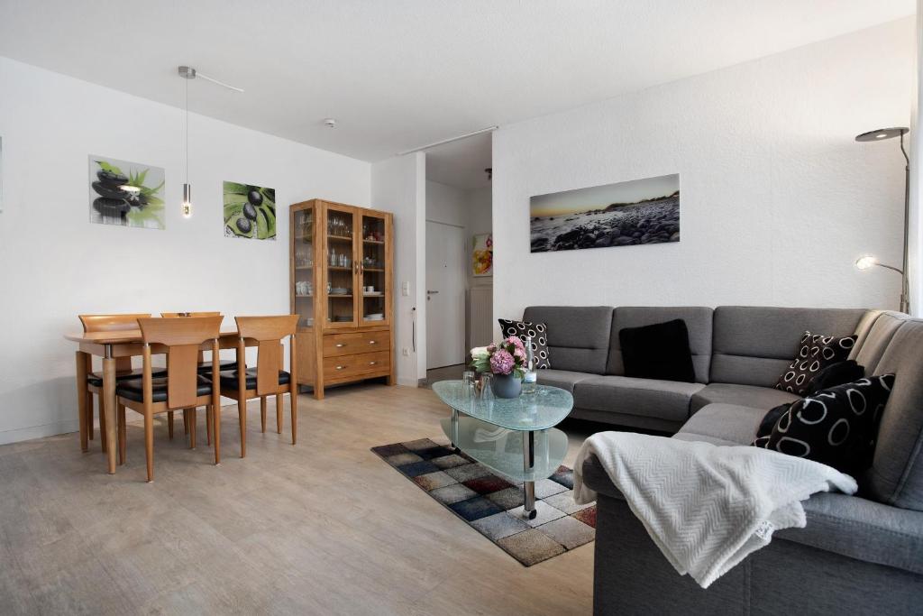 a living room with a couch and a table at Wohnung C1 - Haus A Cappella in Binz