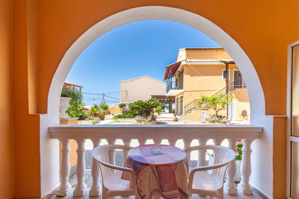 a balcony with a table and two chairs at Mires House Side Ground Floor 4 in Agios Gordios