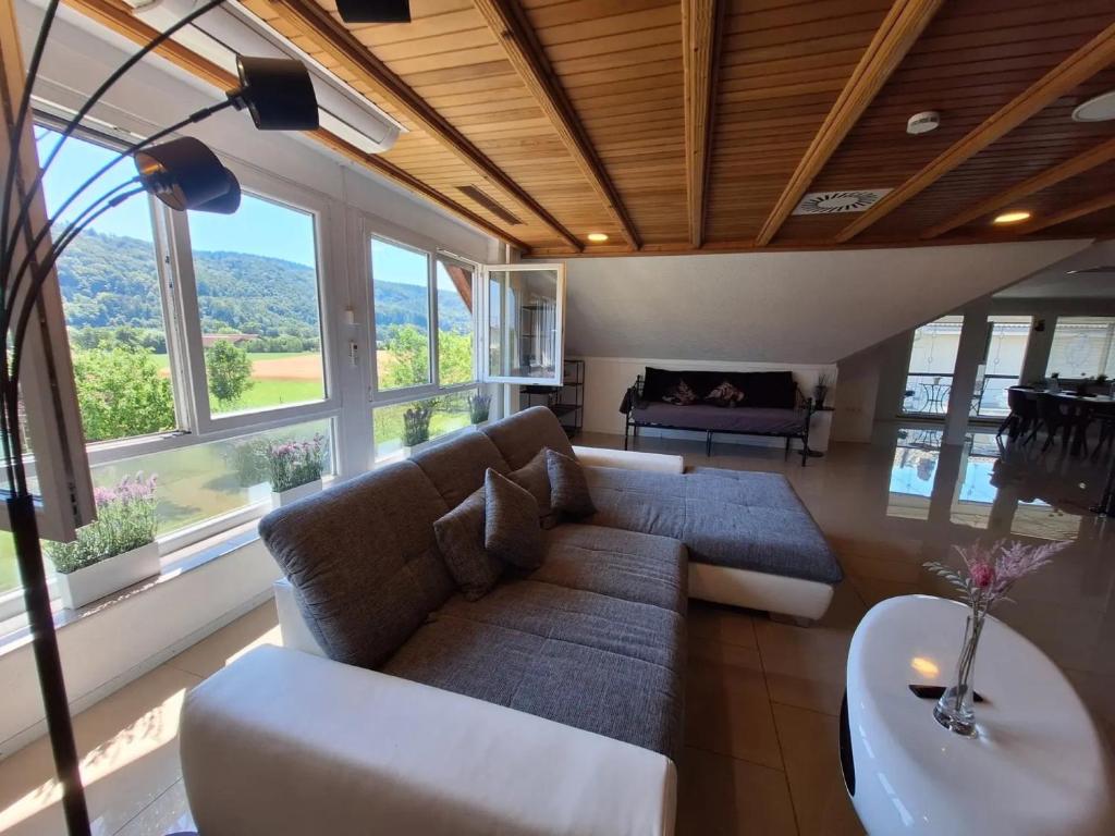 a living room with a couch and a table at Pure Vista Hank Schwarzwaldblick in Luttingen