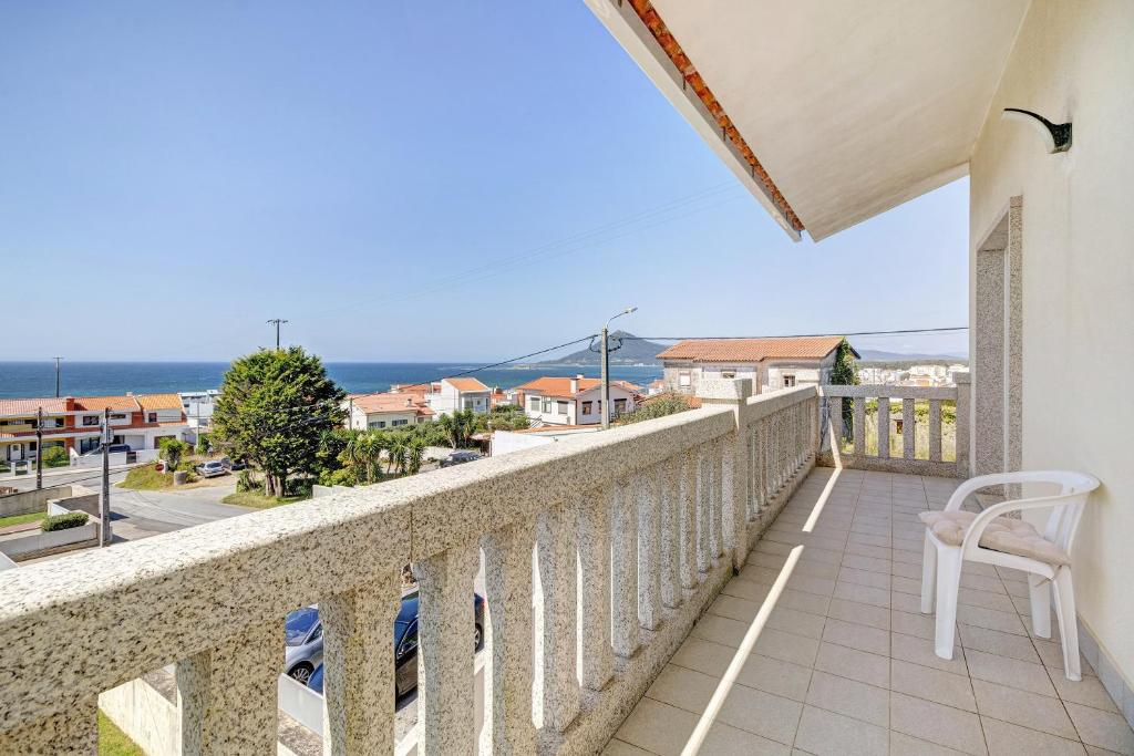 a balcony with a view of the ocean at Casa Dona Lola in Moledo