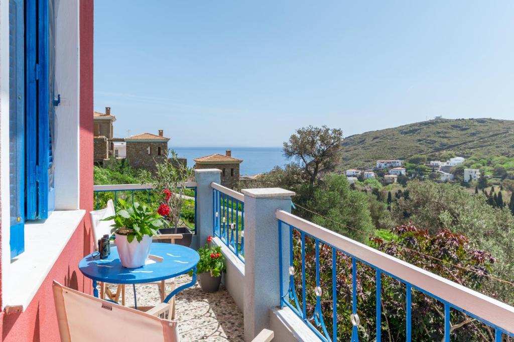 a balcony with a table and a view of the ocean at Stenies'nook in Andros