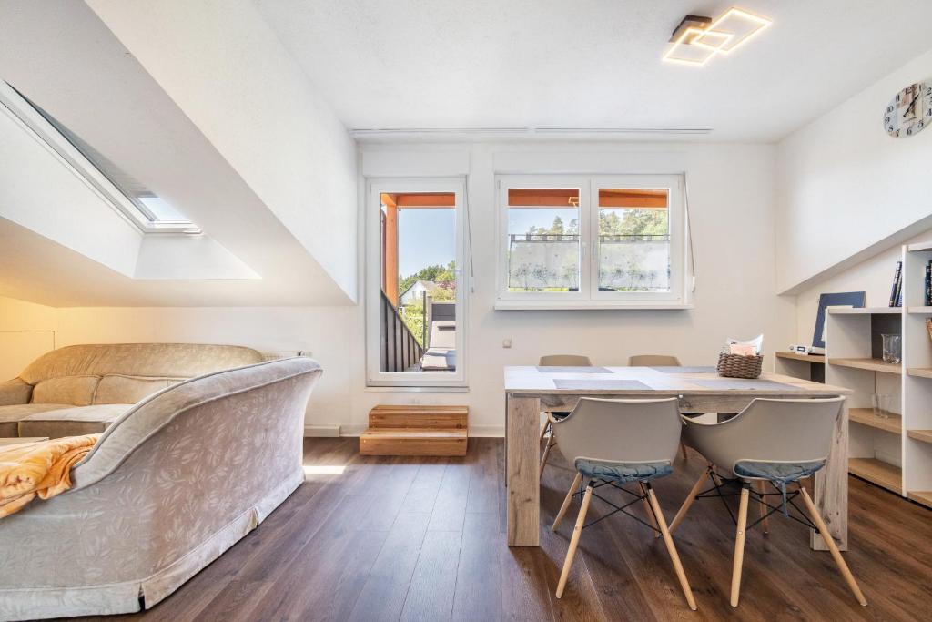 a bedroom with a bed and a table and chairs at Ferienwohnung Luna in Bindlach