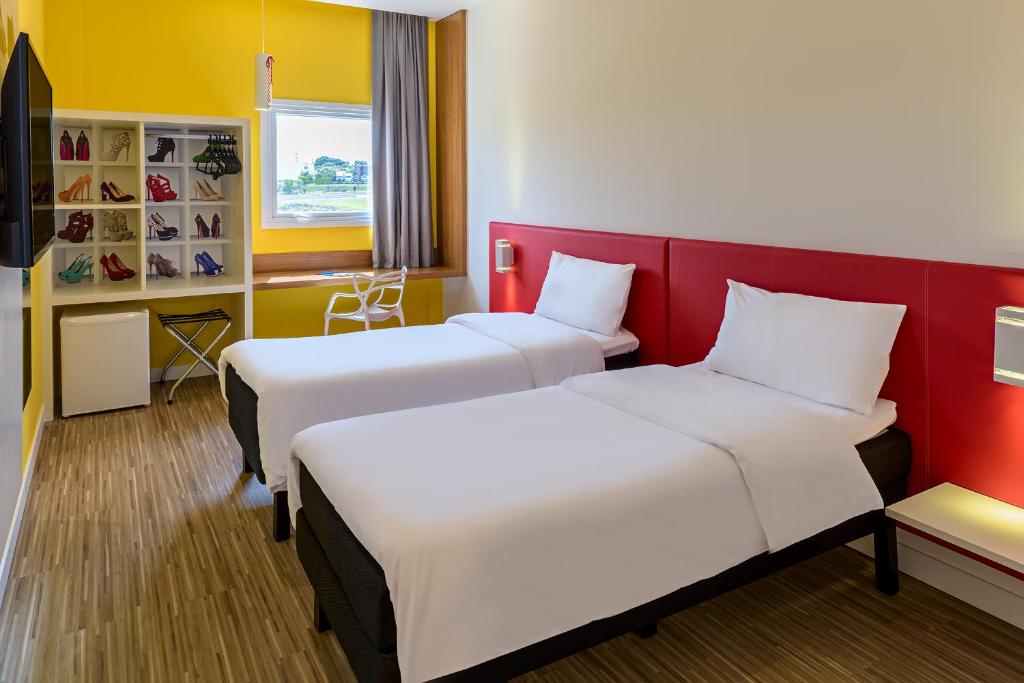 Postel nebo postele na pokoji v ubytování ibis Styles Birigui