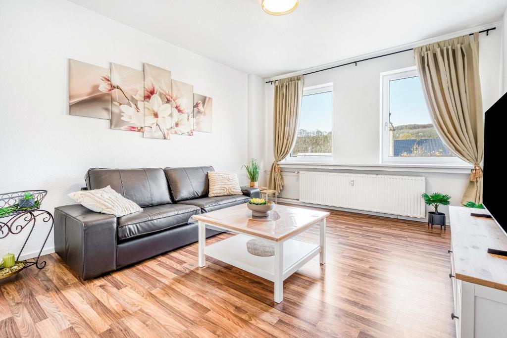 a living room with a couch and a table at Wohnung am Hagener Hbf - 4 Og in Hagen
