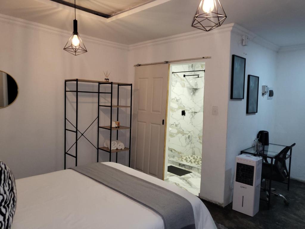 a bedroom with a bed and a sliding glass door at Villa Tlhago Lodge in Ga-Mothapo