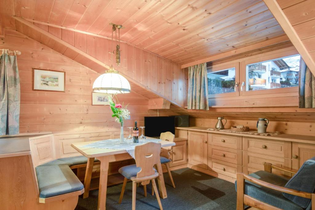a dining room with a table and chairs at Apartments Christa App A in Ortisei