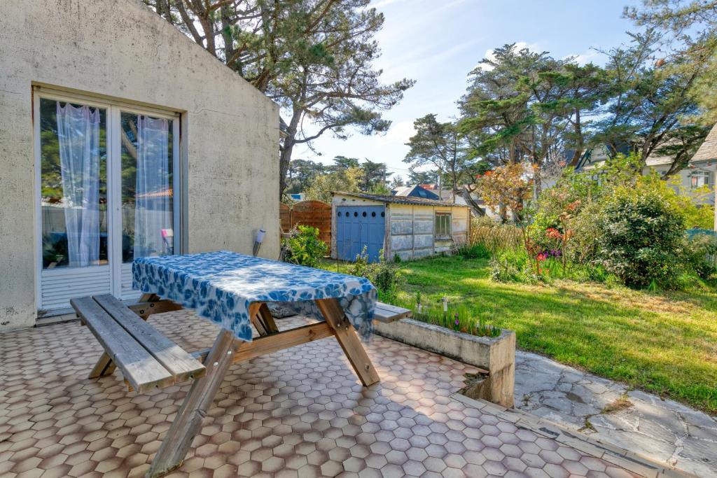a picnic table and a bench on a patio at La Baule in La Baule