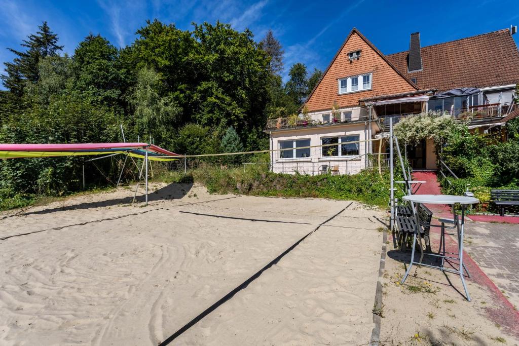 a volleyball court in front of a house at Haus Sonnenberg in Willingen