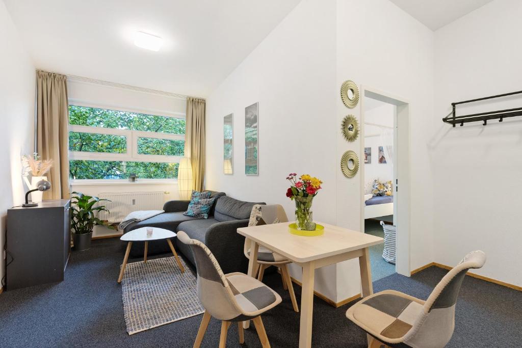 a living room with a couch and a table at Albrechtshof Apartment 3 in Potsdam