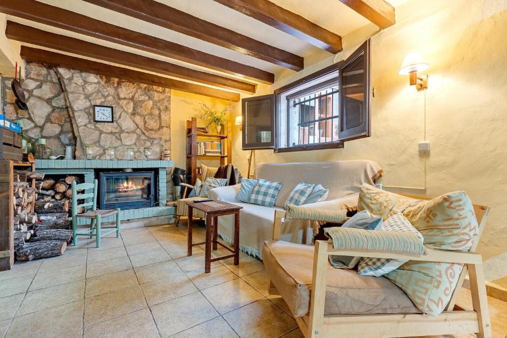 a living room with a couch and a fireplace at Priorat Tranquil in Lloá