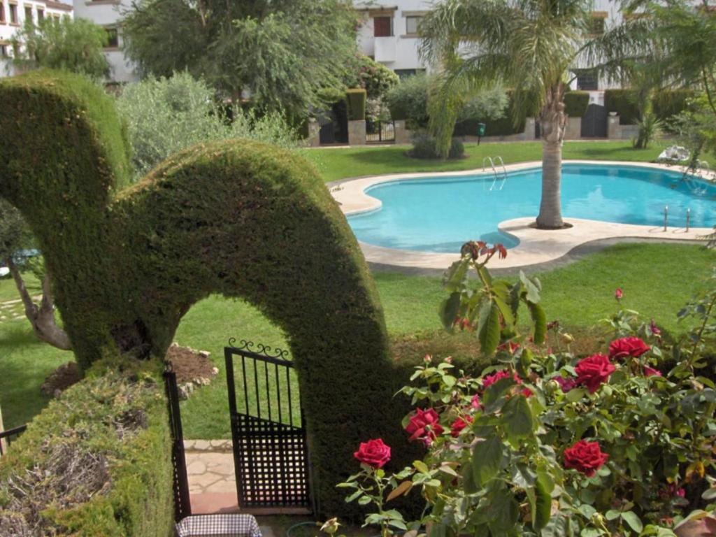 a garden with a fence and a swimming pool at Villa Consuelo in Cambrils