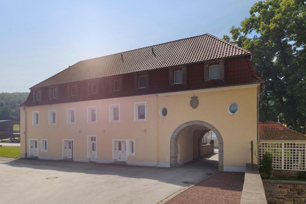 a large building with an archway in front of it at Torhaus Schloss Wocklum in Balve