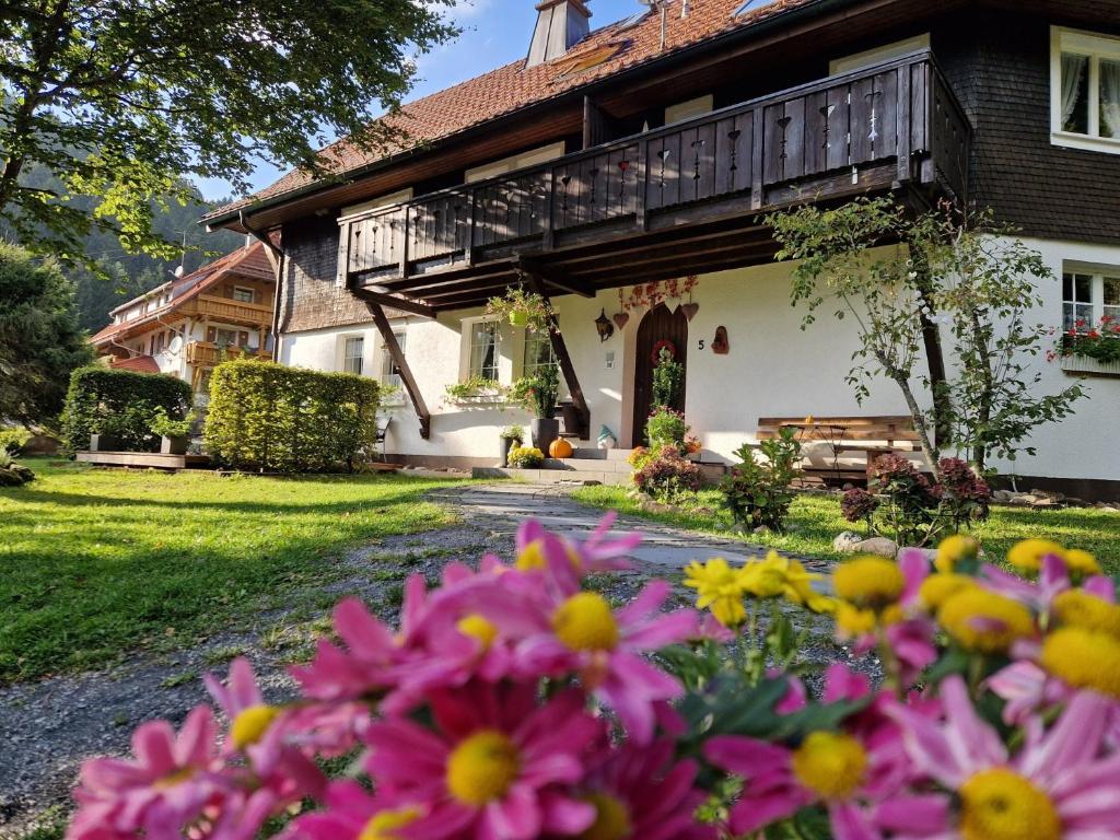 a house with flowers in front of it at Altes Zollhüsli in Schluchsee
