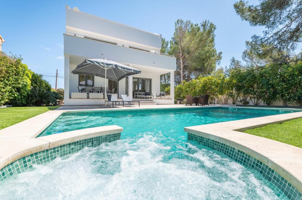 a swimming pool in the backyard of a house at The Tower Villa in El Toro
