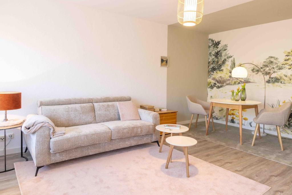 a living room with a couch and a table at Herzlichstharz - Klein und Fein in Bad Lauterberg