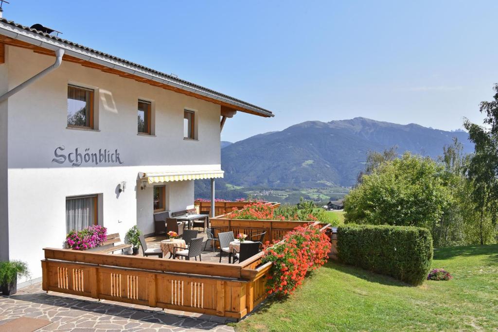 a house with a deck and a patio at Apartment Eisacktal in Mühlbach