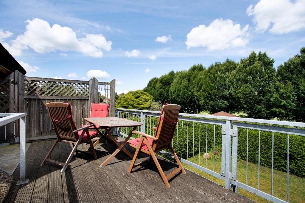 two chairs and a table on a deck at Landhaus Peenemünde in Peenemünde