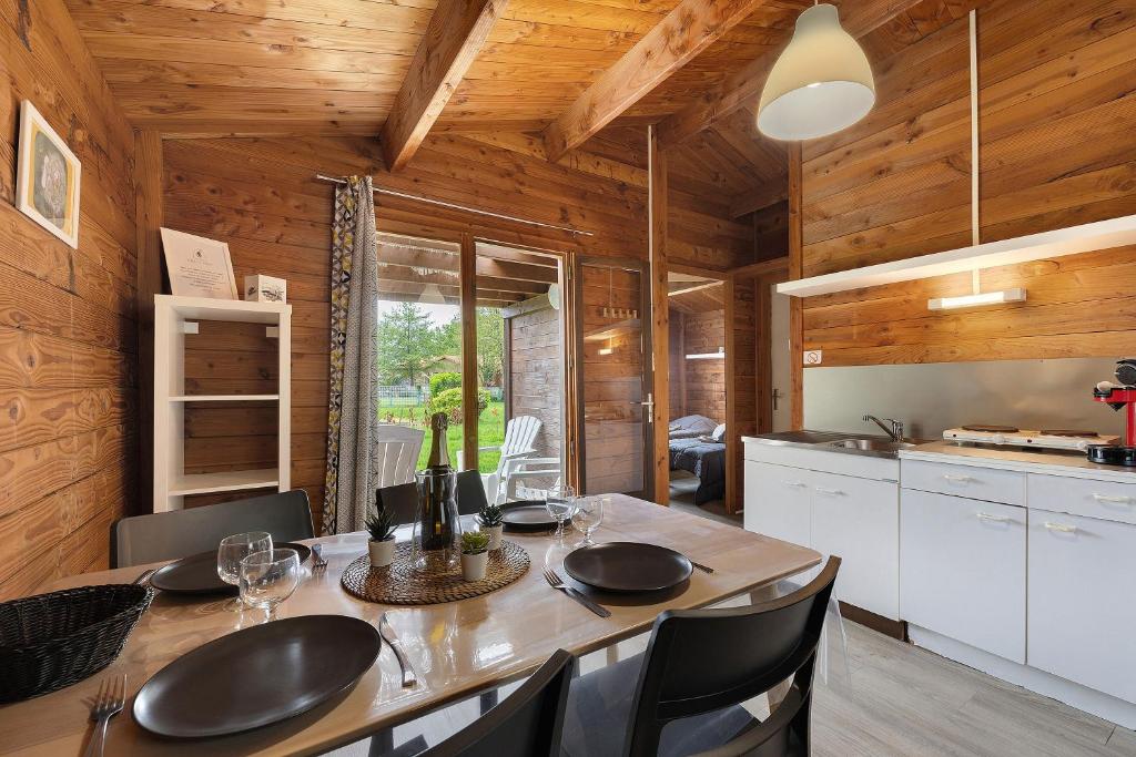 a kitchen and dining room with a table and chairs at Chalet confort 21 in Saint-Gervais