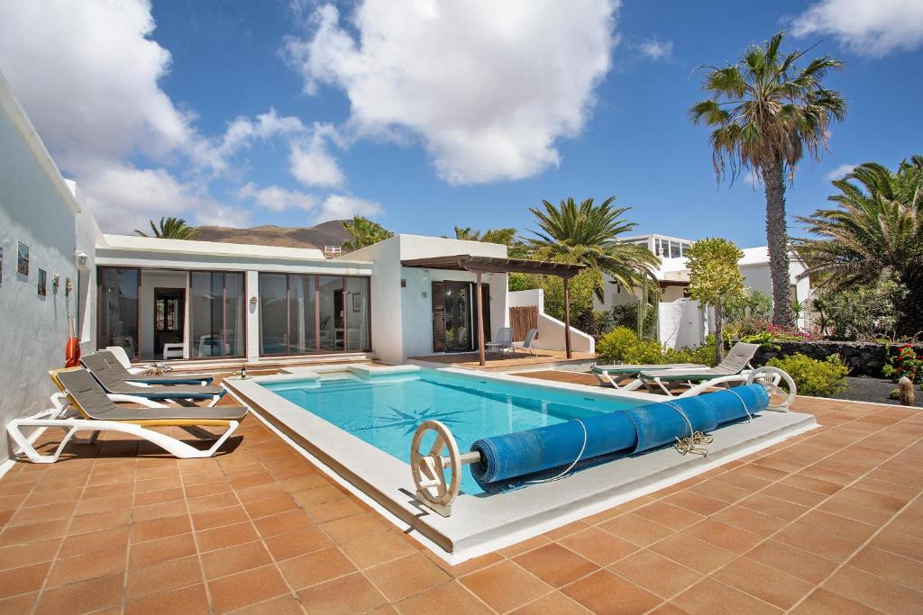 a swimming pool in the backyard of a house at Casa Margarita in Lanzarote