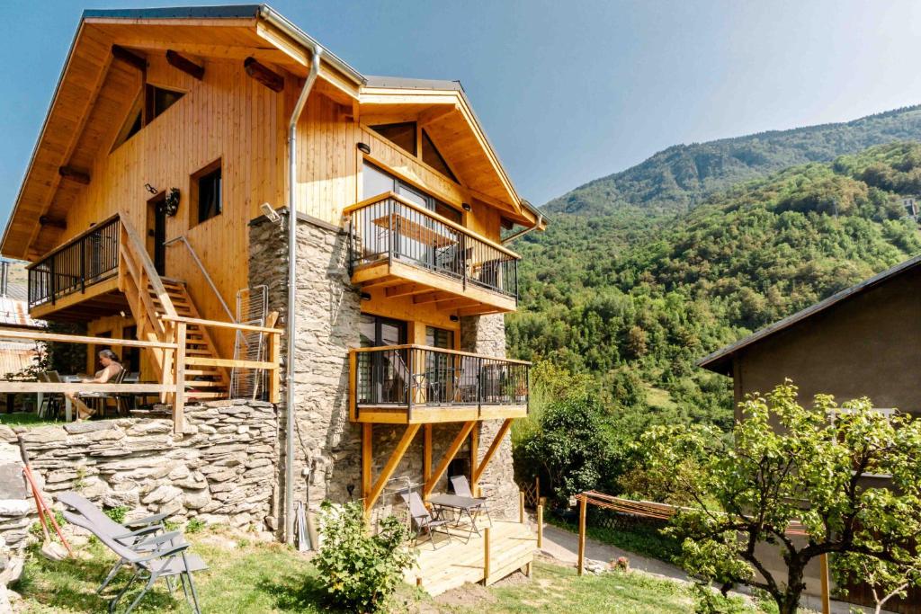 a log building with stairs and a balcony at Agréable Chalet 3 étoiles App 3 in Courchevel