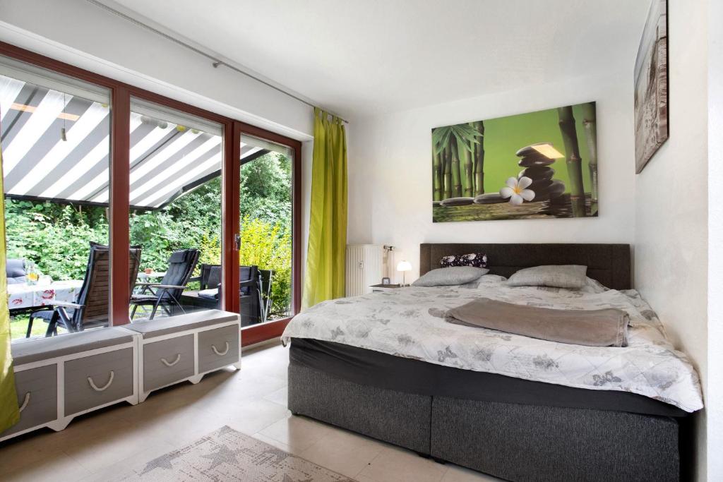 a bedroom with a large bed and a balcony at Ferienpark Gustow B09 in Gustow
