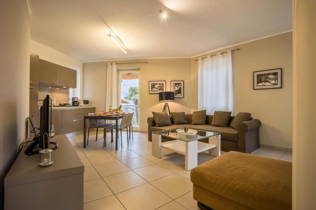 a living room with a couch and a table at Residence La Villa Tesoro in Tignale