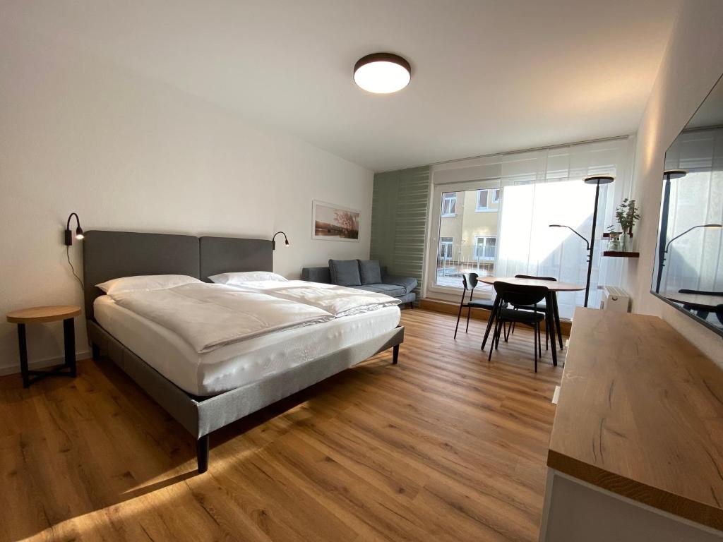a bedroom with a bed and a living room at Myzell in Radolfzell am Bodensee