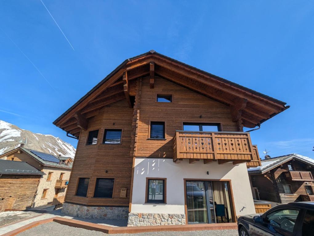 a house with a balcony on top of it at Chalet Kb in Livigno