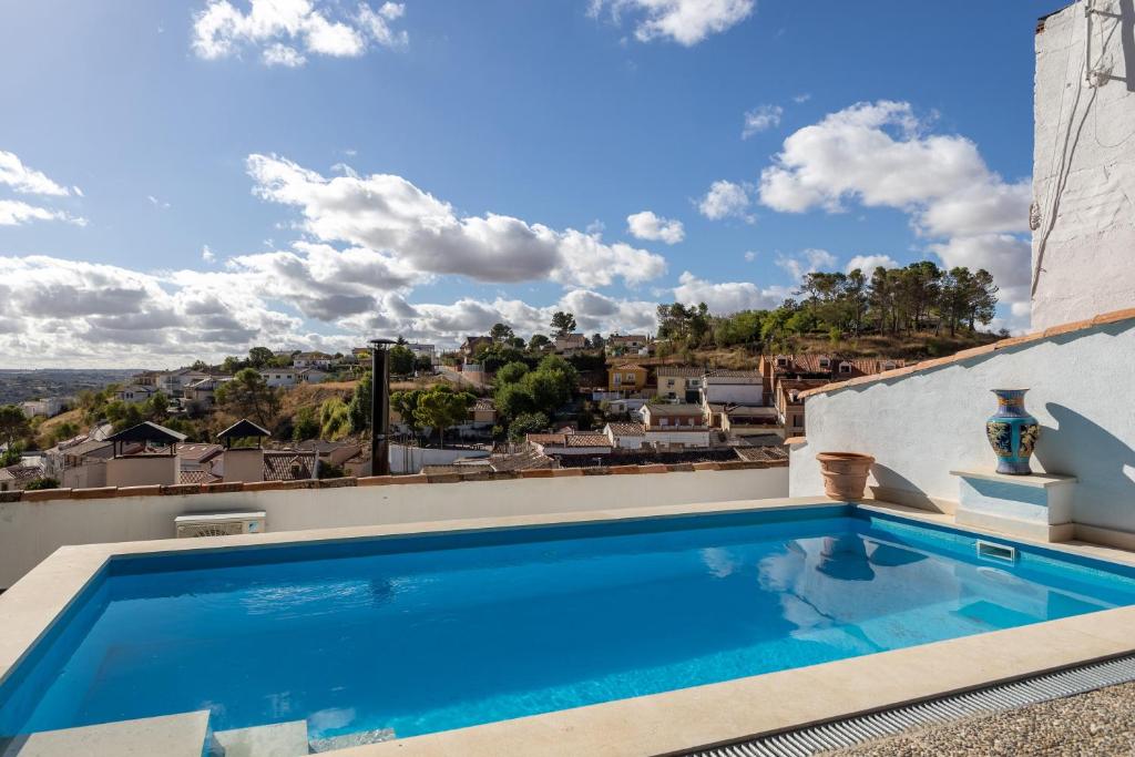 a swimming pool on the roof of a house at Apto Rural La Buganvilla in Valdelaguna