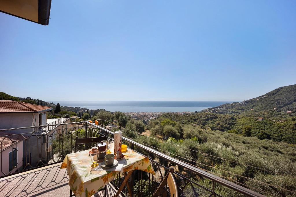 a table on a balcony with a view of the ocean at I Girasoli in Alassio