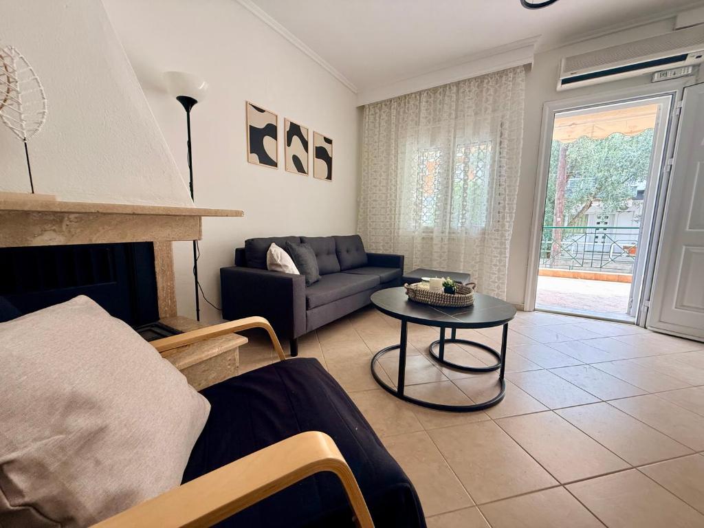a living room with a couch and a table at Casa d'Angelo by Horizon Homes in Orfánion