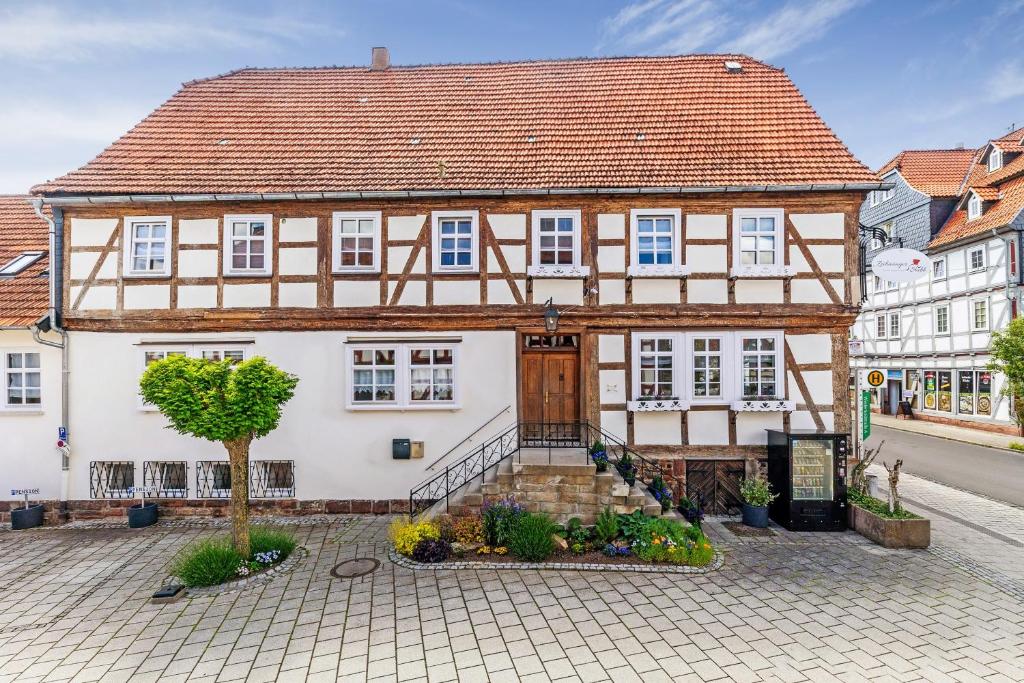 a large white house with a brown roof at Zeihäänger Stubb in Schwalmstadt
