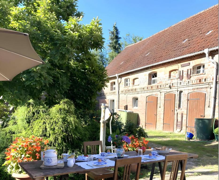 a table in front of a building with an umbrella at Apartments-Schlamau19 in Schlamau