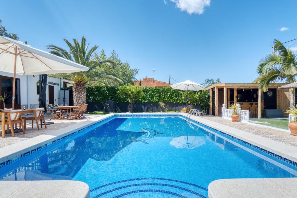a swimming pool in a villa with a house at Park Carpe Diem Studio in Busot