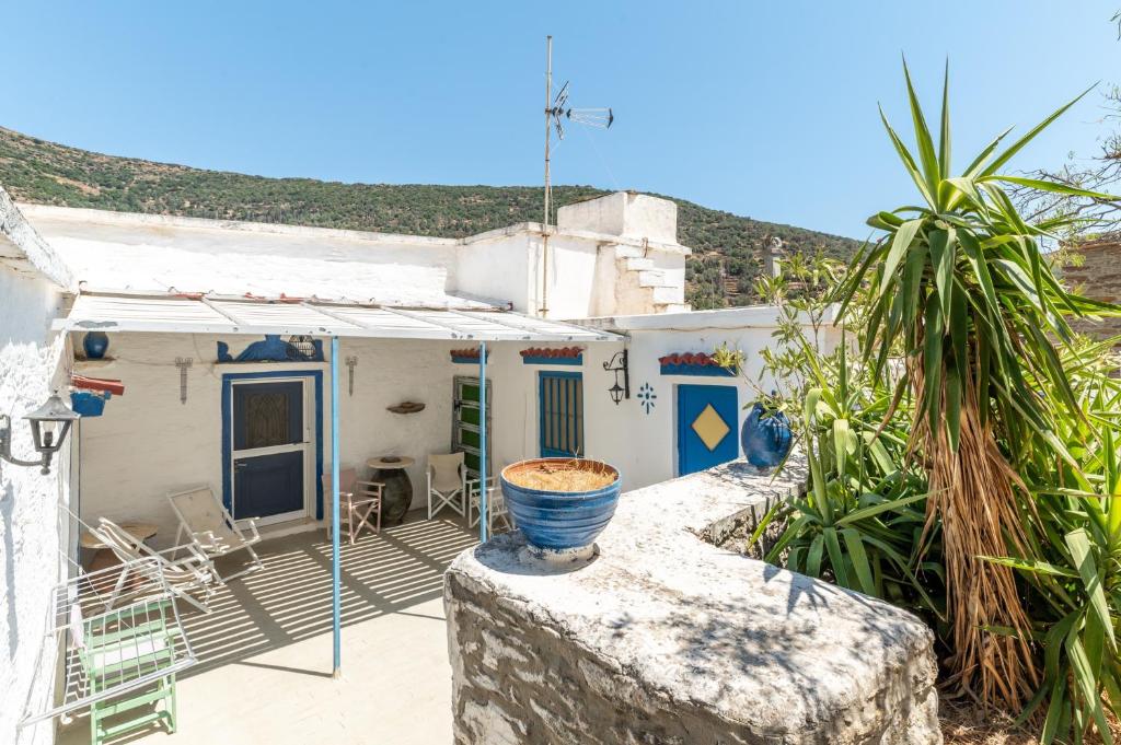a house with a vase on a wall at Andros Traditional House in Andros
