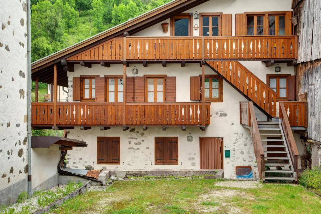 a house with wooden balconies on the side of it at Casa San Giovanni 2 a Vinigo in Vinigo
