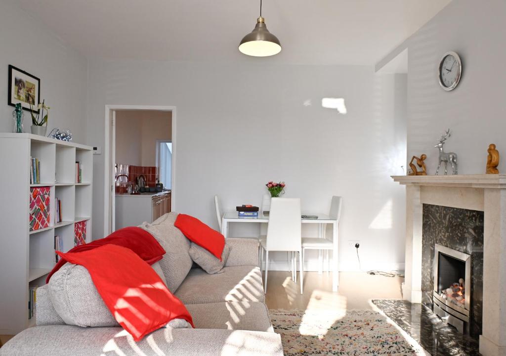 a living room with a couch and a fireplace at 7 Western Hill in Frosterley