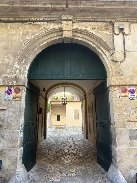 an entrance to a building with an archway at San Leonardo Apartments in Lecce