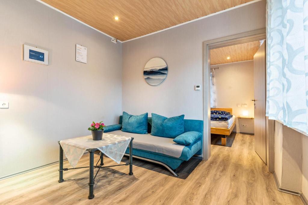 a living room with a couch and a table at Haus Monterosa in Baden-Baden