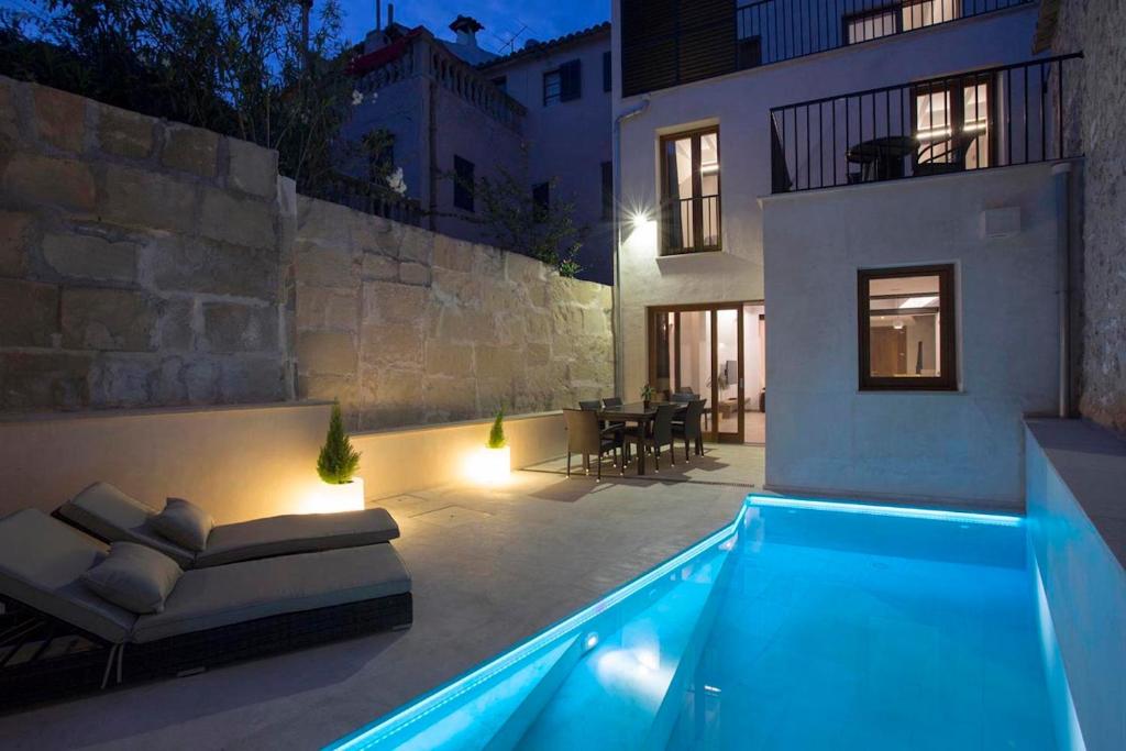a house with a swimming pool at night at Casa Sant Sebastia in Pollença