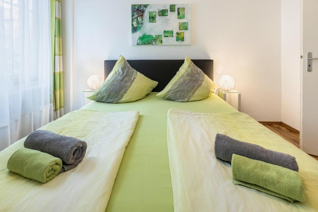 a large bed with two pillows on top of it at Ferienwohnung Stachel A in Konstanz