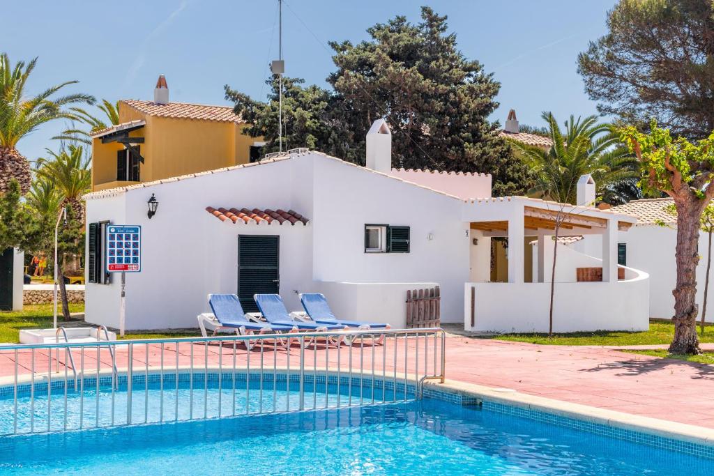 a villa with a swimming pool and a house at Son Xoriguer 5 in Son Xoriguer