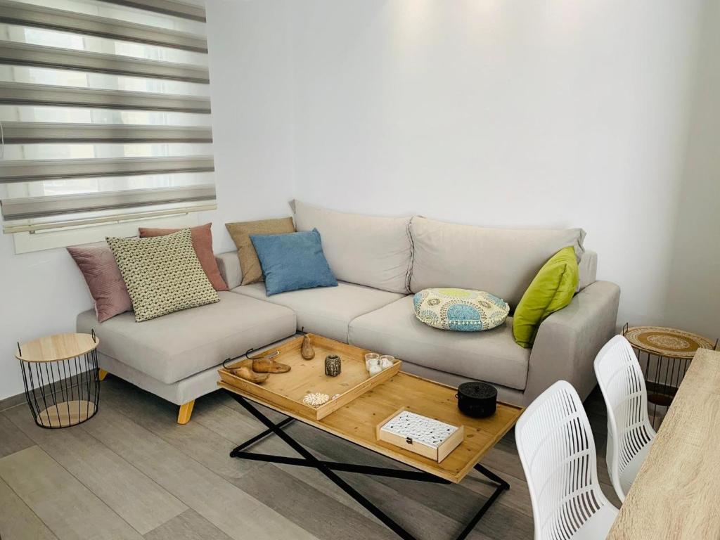 a living room with a couch and a coffee table at Sofias House Fresh And Comfy in Naxos Chora