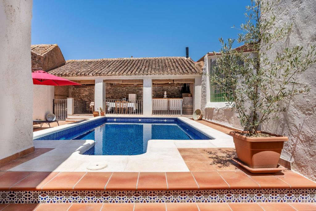 a swimming pool in front of a house at Casa Juan y Loli in Nigüelas