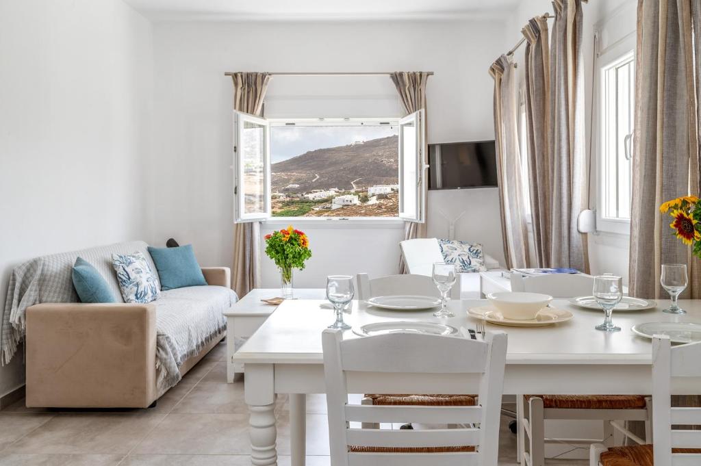 a living room with a table and a couch at Afroditi Ftelia Anemone in Mykonos