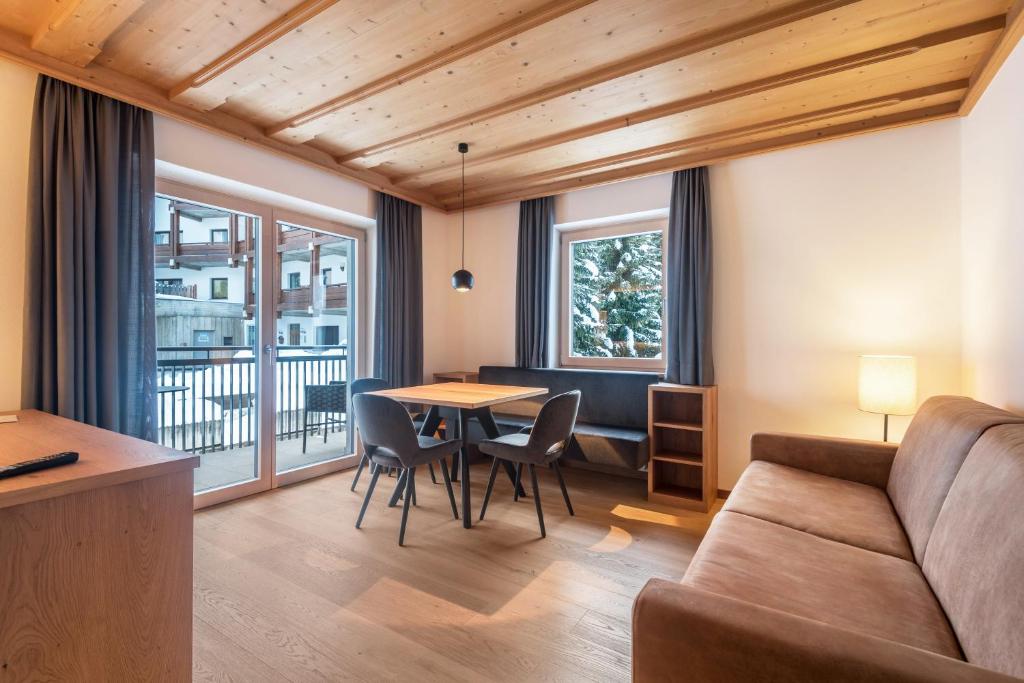 a living room with a couch and a table at La Grambla App Sella in Santa Cristina Gherdëina