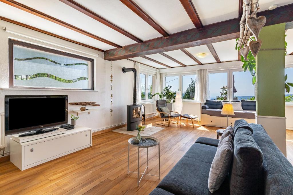 a living room with a couch and a tv at Augensteins Burgzimmer in Seelbach